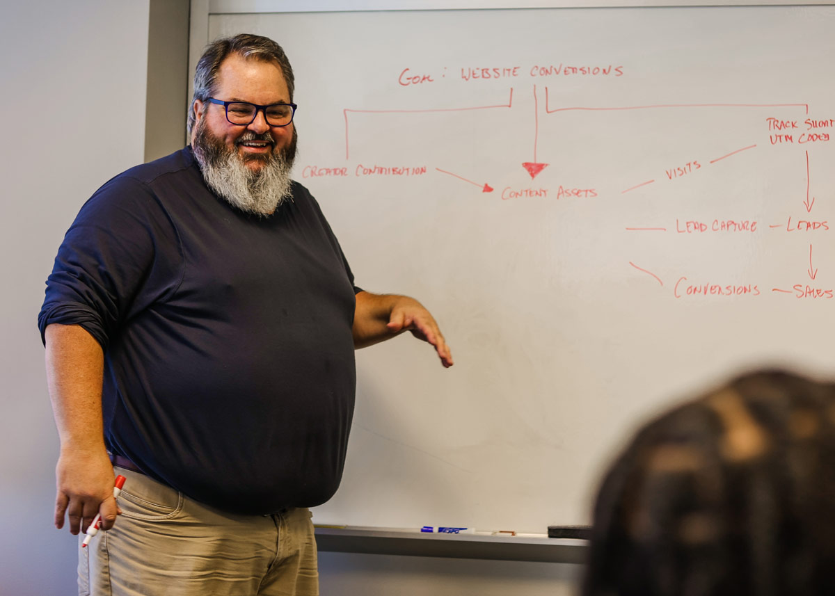 Jason Falls discussing website conversions at a whiteboard